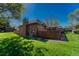 Brick house featuring a well-maintained lawn, patio, and fenced backyard at 30 Eagle Dr, Littleton, CO 80123