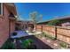 Backyard patio featuring outdoor seating amidst landscaped flowerbeds and a wooden fence at 30 Eagle Dr, Littleton, CO 80123