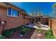 Brick home exterior featuring a patio with outdoor furniture and landscaped garden at 30 Eagle Dr, Littleton, CO 80123