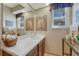 Bright bathroom featuring a vanity with solid surface countertops and decorative accents at 30 Eagle Dr, Littleton, CO 80123