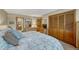 Well-lit bedroom showcasing closet, dresser, and queen bed at 30 Eagle Dr, Littleton, CO 80123