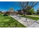 Charming single Gathering home with a two car garage and a lush green lawn in a mature neighborhood at 30 Eagle Dr, Littleton, CO 80123