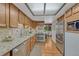 Bright kitchen featuring wood cabinets, stainless steel appliances, granite countertops, and a view to the breakfast nook at 30 Eagle Dr, Littleton, CO 80123