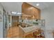 Cozy kitchen with wooden cabinets, granite countertops, and a skylight offering great light at 30 Eagle Dr, Littleton, CO 80123