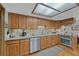Charming kitchen with wood cabinets, granite countertops, stainless steel appliances, and a skylight at 30 Eagle Dr, Littleton, CO 80123