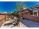 Backyard patio with outdoor seating and blooming flowers in a sunny, fenced yard at 30 Eagle Dr, Littleton, CO 80123