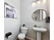 Cozy half bathroom features a pedestal sink, round mirror, and stylish decor for guests at 3699 Makley Cir, Castle Rock, CO 80104