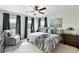 Inviting main bedroom with natural light, a ceiling fan, a comfortable bed, and stylish decor at 3699 Makley Cir, Castle Rock, CO 80104