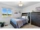 Cozy bedroom with a comfortable bed, a large window, a view of the mountains, and neutral decor at 3699 Makley Cir, Castle Rock, CO 80104