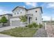 Charming two-story home with gray siding, a well-manicured lawn, and a two-car garage at 3699 Makley Cir, Castle Rock, CO 80104