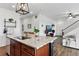 Modern kitchen with granite countertop island, stainless steel appliances, and open view to the living area at 3699 Makley Cir, Castle Rock, CO 80104
