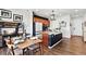 Modern kitchen with stainless appliances, wood cabinets, granite countertops, a center island, and adjacent dining area at 3699 Makley Cir, Castle Rock, CO 80104
