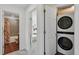 Convenient laundry area with stacked washer and dryer, adjacent to the bathroom and bedroom at 3699 Makley Cir, Castle Rock, CO 80104