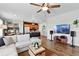Spacious living room with a white sofa, hardwood floors, a ceiling fan, and an open concept to the kitchen and dining area at 3699 Makley Cir, Castle Rock, CO 80104