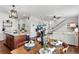 Open floor plan with dining area, island kitchen, a staircase, and a comfortable living area with hardwood floors at 3699 Makley Cir, Castle Rock, CO 80104