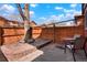 Private backyard patio area with a wooden fence and outdoor seating at 1279 S Sable Blvd, Aurora, CO 80012