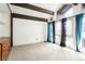 Bright bedroom with large windows, wooden beams, and plush carpeting at 1279 S Sable Blvd, Aurora, CO 80012