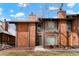 Beautiful townhome with unique wood facade, chimney, and manicured landscaping at 1279 S Sable Blvd, Aurora, CO 80012