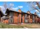 Charming townhome showcasing unique wood facade, well maintained landscaping and a beautiful blue sky at 1279 S Sable Blvd, Aurora, CO 80012