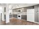 Stylish kitchen featuring grey cabinets, stainless steel appliances, and hardwood floors at 1279 S Sable Blvd, Aurora, CO 80012