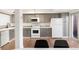 Well-lit kitchen with grey cabinets, white countertops, and modern appliances near dining area at 1279 S Sable Blvd, Aurora, CO 80012
