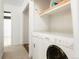 Convenient laundry area equipped with a washer, dryer, and storage shelves at 1279 S Sable Blvd, Aurora, CO 80012