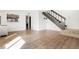 Spacious living room with new floors, a staircase to the upper level, and a kitchen pass-through at 1279 S Sable Blvd, Aurora, CO 80012