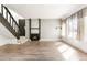 Bright living room features new floors, a fireplace, and a staircase to the upper level at 1279 S Sable Blvd, Aurora, CO 80012