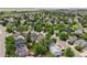 Aerial view of a neighborhood featuring tree-lined streets and well-maintained homes with lush green lawns and landscaping at 4393 E Andover Ave, Castle Rock, CO 80104