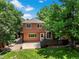 View of a fenced backyard with a green lawn, patio, wood deck, and mature trees, offering a private outdoor space at 4393 E Andover Ave, Castle Rock, CO 80104