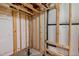 Unfinished basement with wood framing, white plastic sheeting, and black plumbing lines ready for customization at 4393 E Andover Ave, Castle Rock, CO 80104
