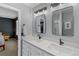 Stylish bathroom featuring double sinks, sleek black fixtures, and modern lighting at 4393 E Andover Ave, Castle Rock, CO 80104
