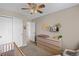 Neutral Bedroom with ceiling fan, changing table, and plenty of room for storage at 4393 E Andover Ave, Castle Rock, CO 80104