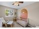 Cozy Bedroom with a crib, decorative sunburst accent, and ample natural light at 4393 E Andover Ave, Castle Rock, CO 80104