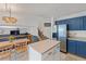 Modern kitchen flowing into a living area, featuring updated appliances and ample storage at 4393 E Andover Ave, Castle Rock, CO 80104