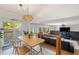Open-concept living room with backyard access, comfortable seating, and modern decor at 4393 E Andover Ave, Castle Rock, CO 80104