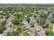 Aerial of homes in a neighborhood with mature trees, yards, and streets at 4393 E Andover Ave, Castle Rock, CO 80104