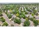 Aerial of homes in a neighborhood with mature trees, grass, and well-maintained streets at 4393 E Andover Ave, Castle Rock, CO 80104