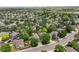 Panoramic aerial showcases a tranquil neighborhood with mature trees and diverse home styles at 4393 E Andover Ave, Castle Rock, CO 80104