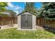 Backyard features a gray plastic storage shed with double doors and a garden area, perfect for outdoor storage at 4393 E Andover Ave, Castle Rock, CO 80104