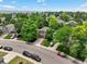 Aerial shot of a home with mature trees and landscaping on a quiet street in a residential area at 4393 E Andover Ave, Castle Rock, CO 80104