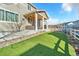 Backyard featuring artificial turf, patio with outdoor seating and easy access to the home at 2594 Scoter Ln, Castle Rock, CO 80104