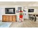 Basement living area with TV, wooden cabinet, mounted helmet, and vintage style popcorn machine at 2594 Scoter Ln, Castle Rock, CO 80104