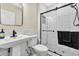Updated bathroom with subway tile, modern fixtures, and glass-enclosed shower with black hardware at 2594 Scoter Ln, Castle Rock, CO 80104
