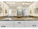 Bright bathroom featuring a double vanity with stone countertops and white cabinets at 2594 Scoter Ln, Castle Rock, CO 80104