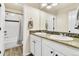 Bathroom features a double sink vanity with granite countertops and a shower/tub with tiled walls at 2594 Scoter Ln, Castle Rock, CO 80104