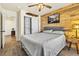 Inviting bedroom with wood accent wall, closet with sliding doors, and stylish furnishings at 2594 Scoter Ln, Castle Rock, CO 80104