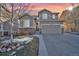 Charming two-story home with stone accents, well-manicured lawn, and attached two-car garage at 2594 Scoter Ln, Castle Rock, CO 80104