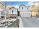Charming home with a two-car garage, stone accents, and landscaped front yard at 2594 Scoter Ln, Castle Rock, CO 80104