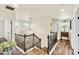 Upstairs landing with railing, chandelier, wood floors, and an abundance of natural light at 2594 Scoter Ln, Castle Rock, CO 80104